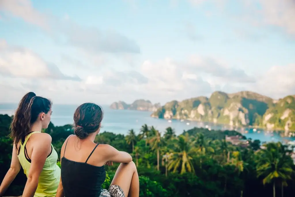 Two female travel friends look over Koh Phi Phi in Thailand.